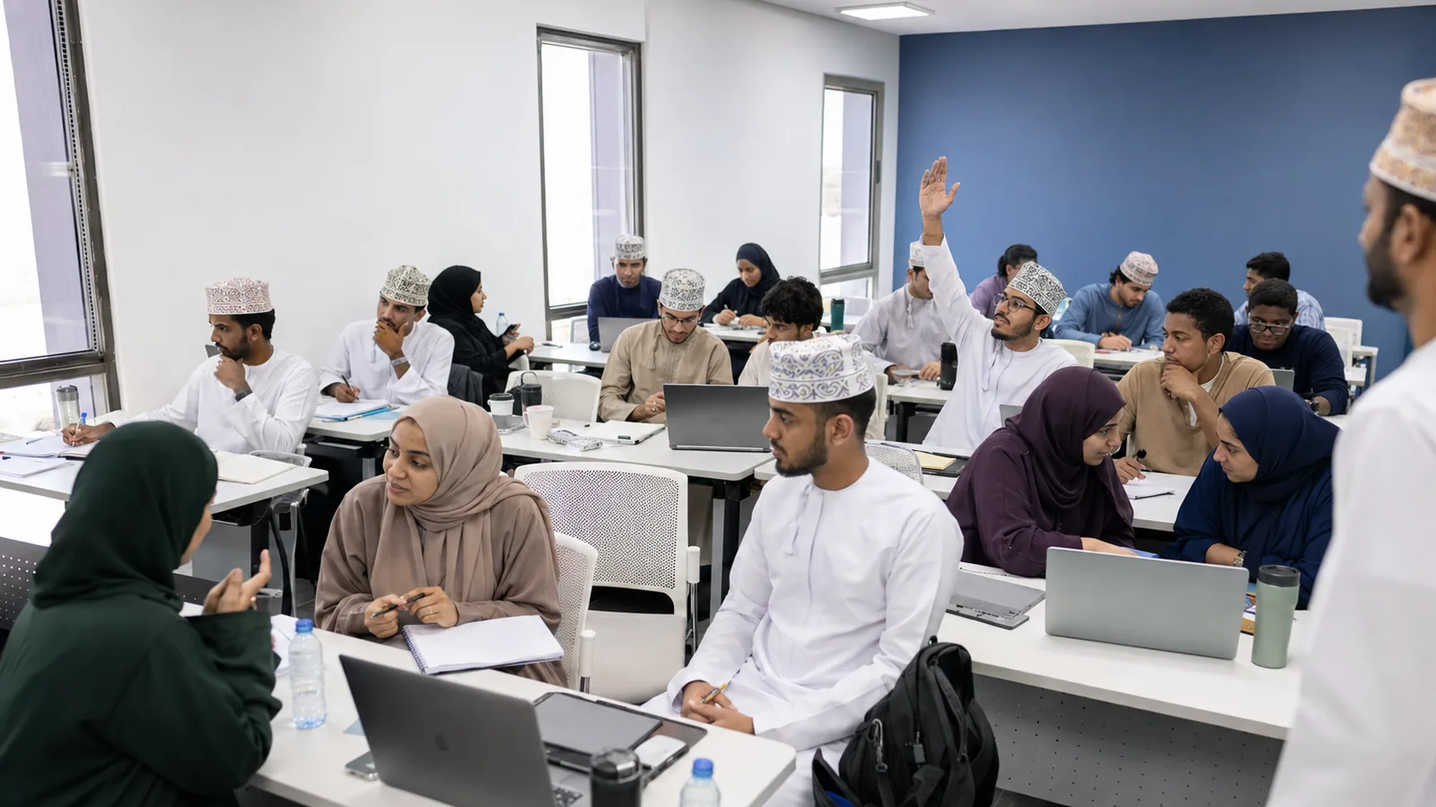 Omani students in a classroom session, hands raised in discussion
